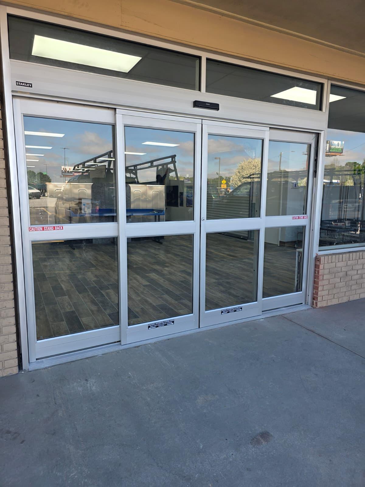 Stanley automatic sliding entrance installed at a new-build laundry — exterior view ready for opening day.