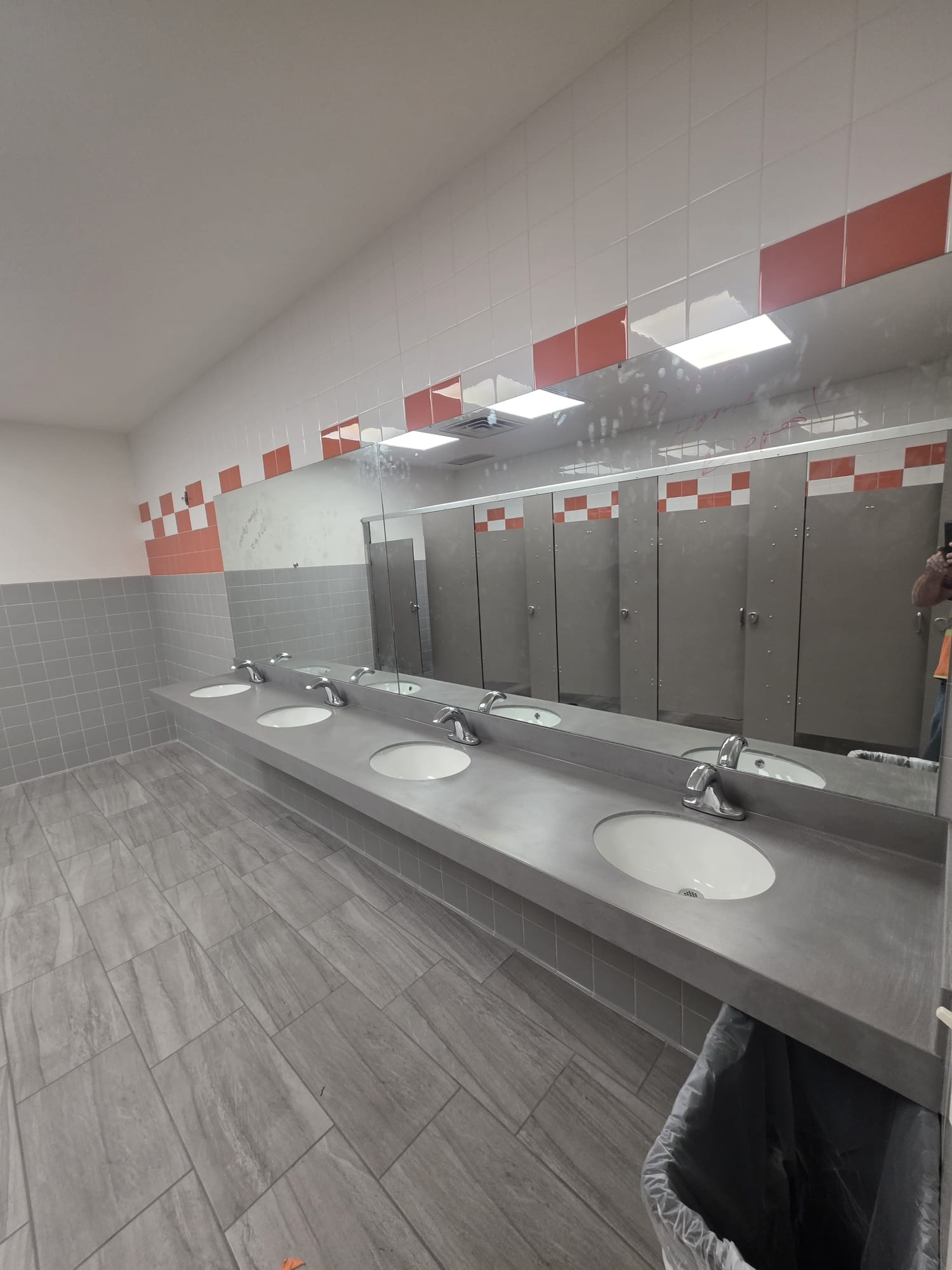 New main restroom vanity, mirrors, and tile finishes installed during a renovation at a Home Depot distribution center.