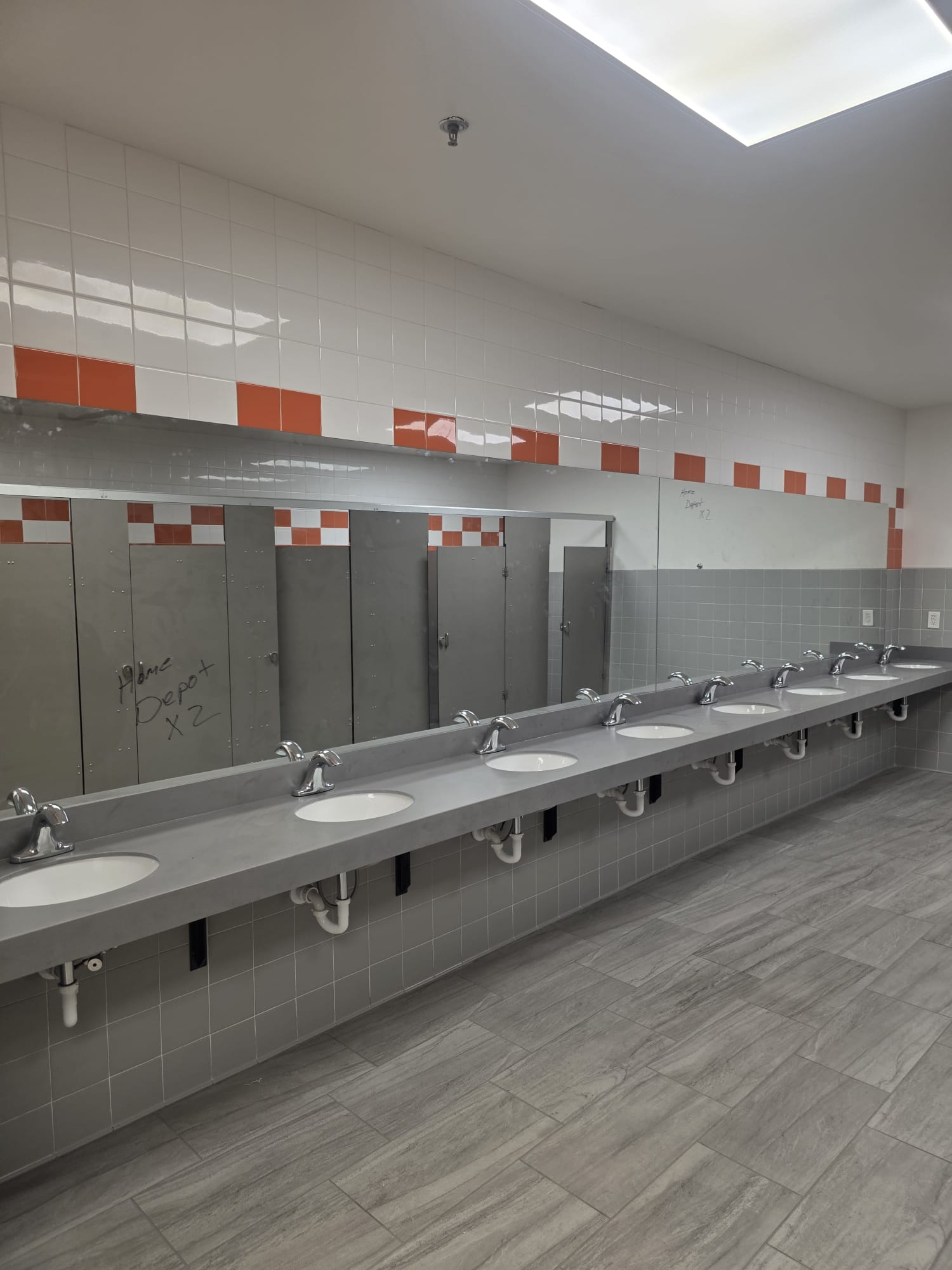 Full sink run with stainless partitions and refreshed tile — completed while the DC stayed operational.