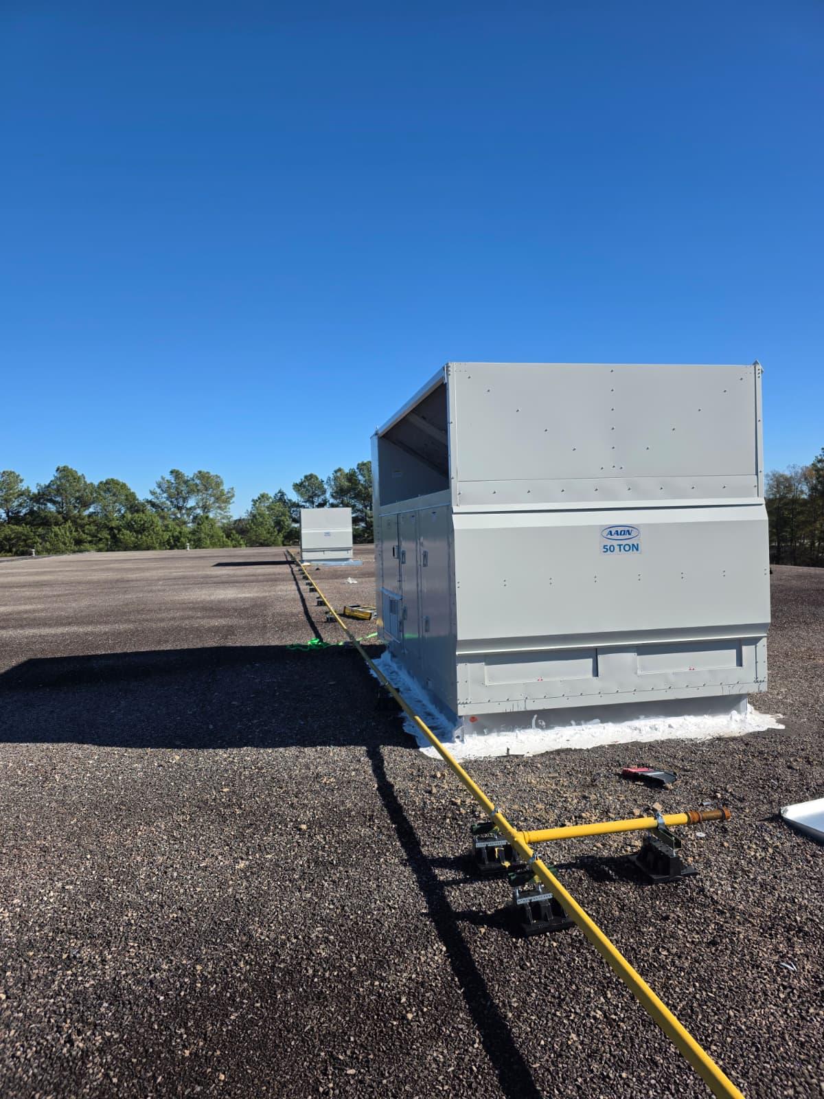 50-ton AAON rooftop unit set and tied into gas line on a commercial roof.