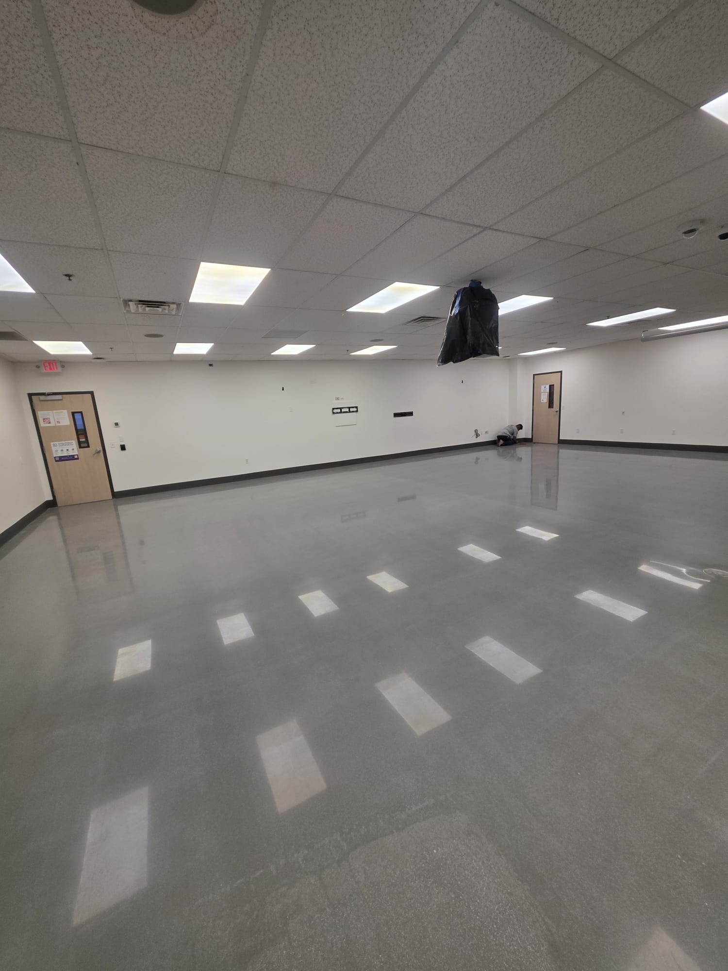 Polished concrete breakroom floor finished while interior trades wrapped up overhead work.