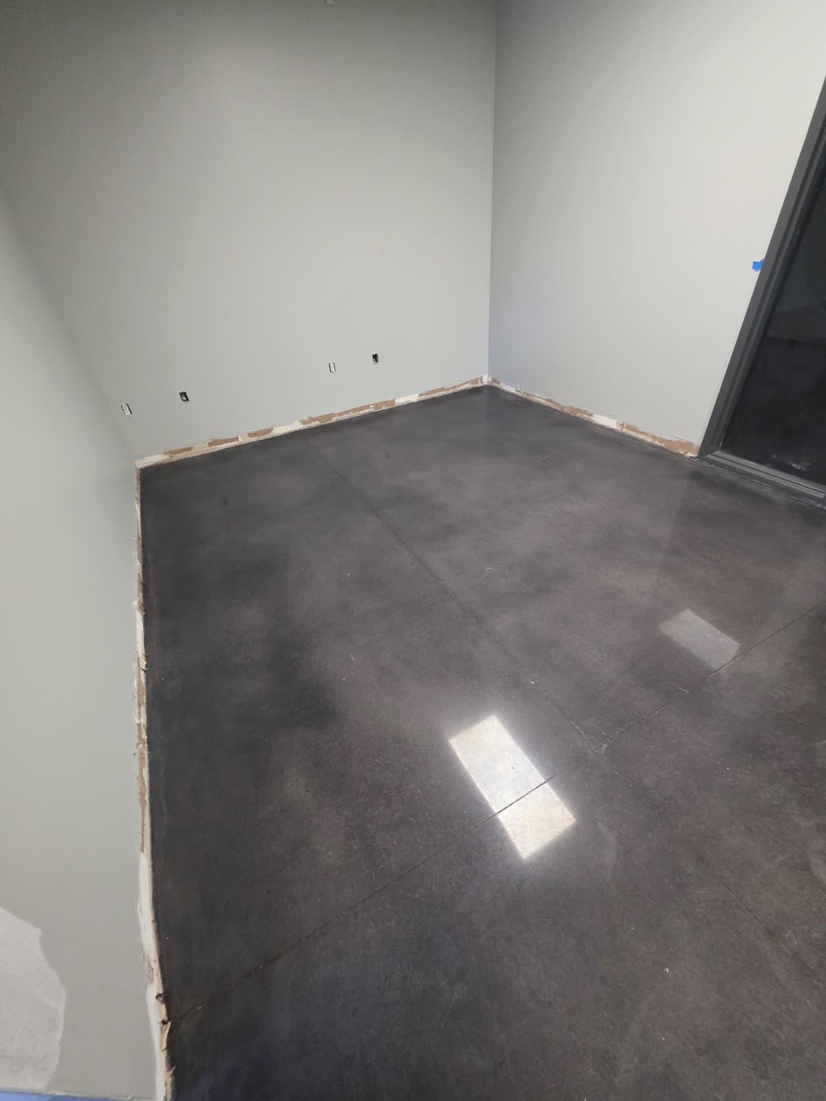 Corner detail of the charcoal polish — even color, tight saw-cut joints, clean wall edge.