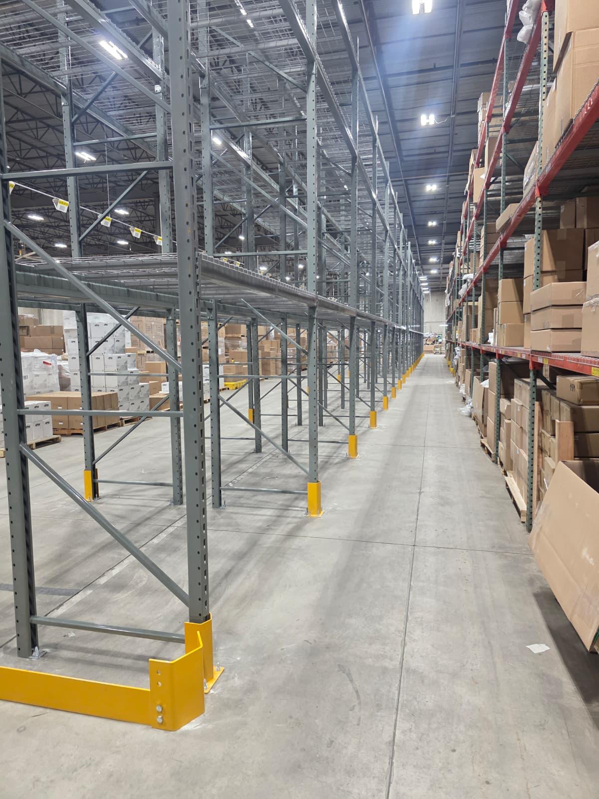 End-of-aisle guards and base protectors lining a full racking run.